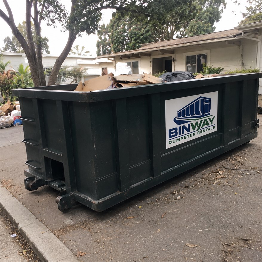 Dumpster at the kerbside outside an apartment building during a property cleanout
