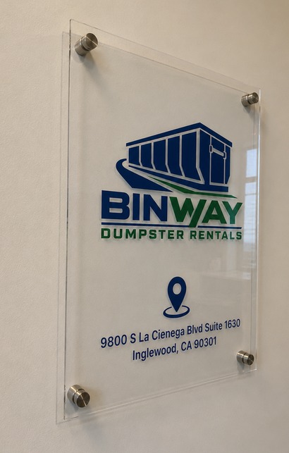 Angled view of the Binway Dumpster Rentals office wall sign